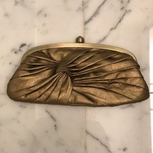 Accessorize gold clutch bag with shoulder strap